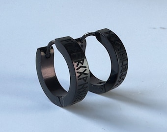 May include: A pair of black hoop earrings with a black metal finish. The earrings are engraved with runes.