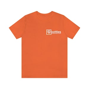 May include: Orange t-shirt with a white logo that says "99 Bottles Taproom & Bottle Shop"