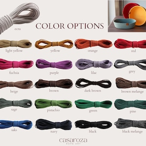 May include: Colour options for rope baskets, shown as spools of rope in various colours, including ecru, light yellow, yellow, orange, red, fuchsia, purple, lilac, grey, beige, brown, dark brown, brown melange, sage, pistachio, green, pine, saks, navy, black, and black melange. The text "COLOR OPTIONS" is displayed above the spools of rope.