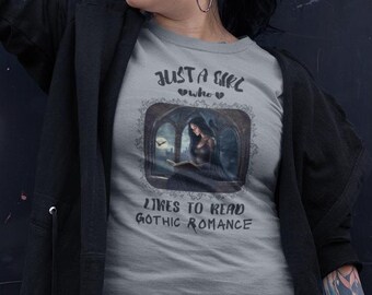 May include: A gray t-shirt with the text "Just a girl who likes to read gothic romance" and an illustration of a woman reading a book in a gothic setting.