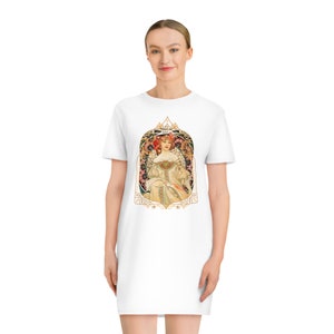 May include: White t-shirt dress with a vintage art nouveau illustration of a woman in a floral crown and a white dress. The illustration is framed in a gold ornate border.
