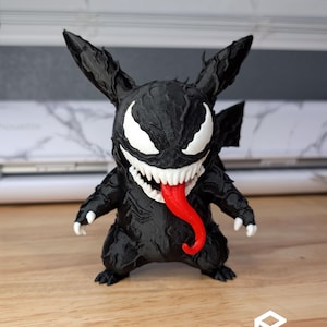 May include: A black figurine featuring a character with pointed ears, a wide mouth filled with sharp white teeth, and a long red tongue. The figure has white eyes and a textured black body. The text EXTRUSIONARY DESIGNS is visible at the bottom.