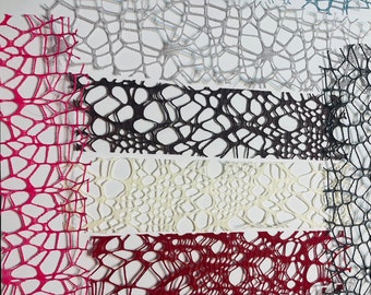 May include: Assortment of lace fabric samples in various colors, including pink, red, white, black, and blue. The lace is delicate and intricate, with a variety of patterns.