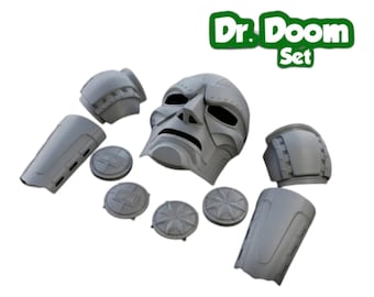 May include: A gray Dr. Doom Set consisting of a molded mask, two shoulder pauldrons, two forearm bracers, and four circular decorative plates. The components feature rigid, sculpted details and are presented as a collection of costume armor parts.