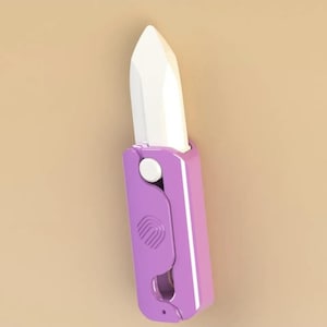Puede incluir: Una herramienta en forma de lápiz labial morado y blanco. La herramienta tiene una punta blanca en ángulo y un mango morado con un botón blanco y un diseño curvo. El fondo es de color beige liso.