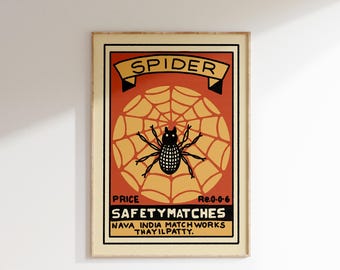 Puede incluir: Etiqueta de caja de cerillas de estilo vintage con una araña negra sobre una telaraña amarilla y naranja. La etiqueta dice "SPIDER SAFETY MATCHES NAVA INDIA MATCH WORKS THAYILPATTY. PRICE Re.0-0-6".