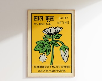 May include: A vintage matchbox label with a yellow background featuring a green and white flower illustration. The text on the label reads "Lal Fool" in Hindi, "50's Price 20 Ps.", "Safety Matches", "Subbanaicker Match Works, Sankarapadiapuram."