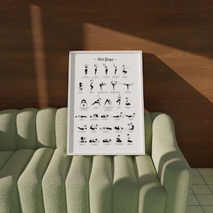 May include: A white framed poster with the title "Hot Yoga" and a black and white illustration of 36 different yoga poses. Each pose has a name written below it.