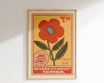 Puede incluir: Etiqueta vintage de caja de cerillas con una flor roja con un centro azul, hojas verdes y el texto "FUL" en un círculo amarillo. La etiqueta también incluye el texto "UNITED MATCH COMPANY KADAMBUR." y "PRICE 3 NP."