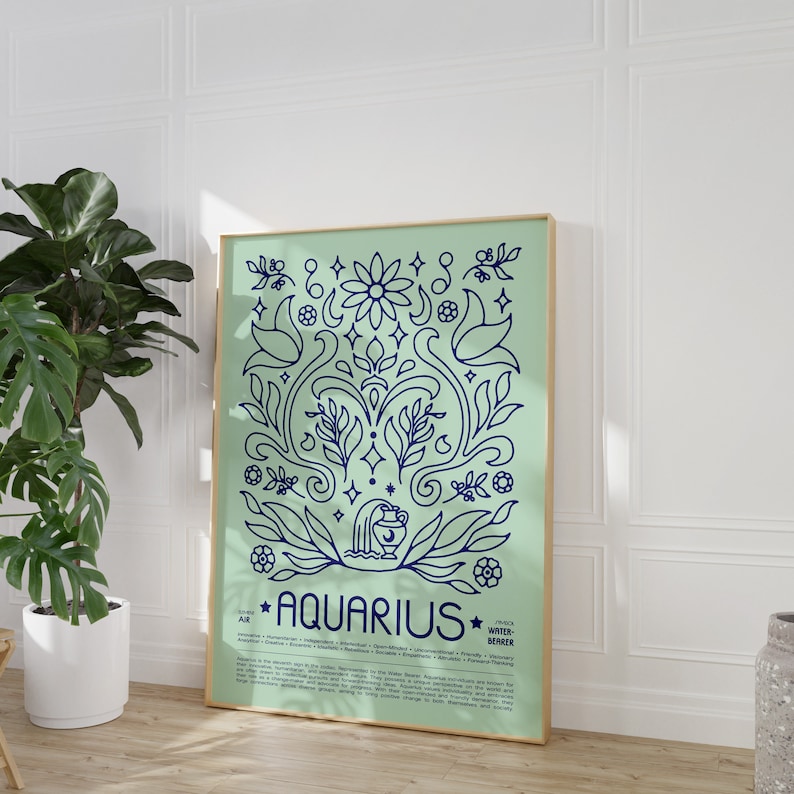 May include: A light blue and green poster with a gold frame featuring a stylized illustration of the astrological sign Aquarius. The poster includes the text "Aquarius" and a description of the zodiac sign.