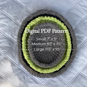 May include: Three crocheted baskets in varying sizes, nested together. The largest is gray, the medium is lime green, and the smallest is gray. Text on the image reads "Digital PDF Pattern" with size details: Small 7" x 5", Medium 9.5" x 7.5", and Large 11.5" x 9.5".