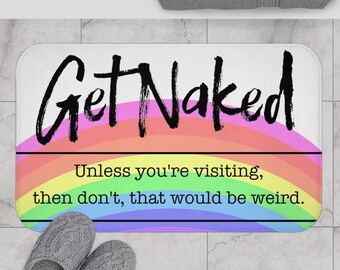 May include: A white bath mat with a rainbow design and the text "Get Naked" in black. The text below the rainbow reads "Unless you're visiting, then don't, that would be weird."