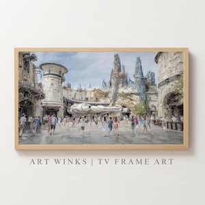 May include: A framed art print depicting a bustling scene from a Star Wars-themed land. The artwork features a detailed rendering of the Millennium Falcon, buildings, and a crowd of people. The frame is a light wood color. Text at the bottom reads "ART WINKS | TV FRAME ART."