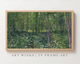 May include: A framed landscape painting of a forest scene. The artwork depicts a lush green forest with tall trees and a path winding through the undergrowth. The painting is in a light wooden frame. The text "ART WINKS | TV FRAME ART" is at the bottom.
