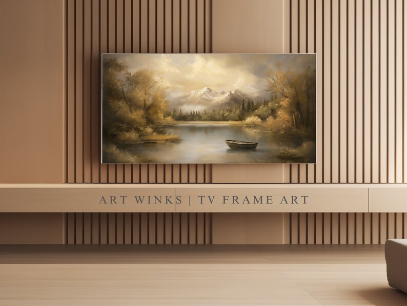 May include: A framed landscape painting of a lake with mountains in the background. The lake is surrounded by trees and there is a small boat in the water. The painting is in a brown frame and is hanging on a wall with wood paneling.