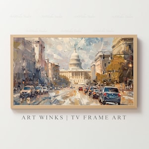 May include: A framed art print of a cityscape with the U.S. Capitol building in the background. The painting features a street scene with cars and buildings in shades of beige, brown, and blue. The text "ART WINKS | TV FRAME ART" is at the bottom.