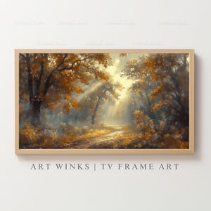 May include: A framed landscape art print featuring a forest scene with a path. The artwork showcases trees with golden leaves, bathed in sunlight. The text "ART WINKS | TV FRAME ART" is displayed at the bottom of the frame.