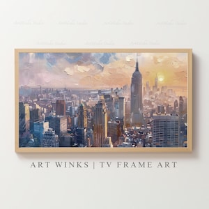 May include: An oil painting of a cityscape, featuring the Empire State Building and other skyscrapers under a sunset sky. The artwork is framed in a light wood frame. The text "ART WINKS | TV FRAME ART" is at the bottom.
