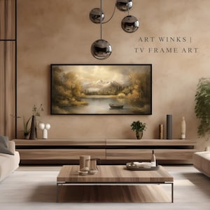 May include: A living room interior design with a brown leather sofa, a wooden coffee table, and a large framed painting of a lake scene hanging above a wooden entertainment center. The text "ART WINKS | TV FRAME ART" is displayed in the upper right corner of the image.