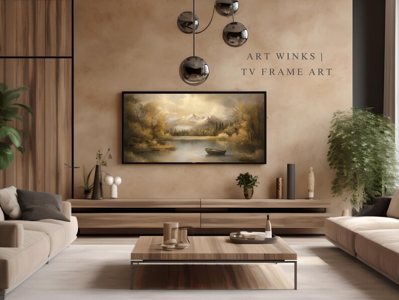 May include: A living room interior design with a brown leather sofa, a wooden coffee table, and a large framed painting of a lake scene hanging above a wooden entertainment center. The text "ART WINKS | TV FRAME ART" is displayed in the upper right corner of the image.