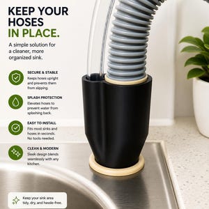 Pode incluir: Um suporte de mangueira preto com base e acabamento bege, projetado para manter as mangueiras da pia no lugar. A imagem mostra uma mangueira cinza ondulada e um tubo transparente. O texto na imagem diz "Keep your hoses in place."