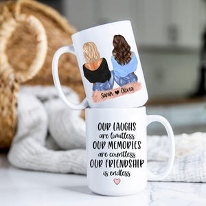 May include: Two white ceramic mugs stacked. The top mug features an illustration of two friends with the names "Sarah" and "Olivia." The bottom mug has the text "Our Laughs are limitless, Our Memories are countless, Our Friendship is endless."