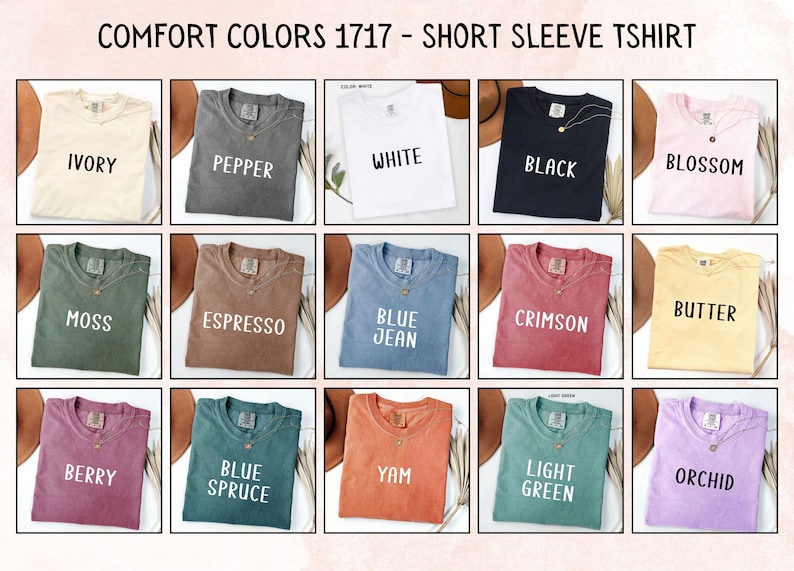 May include: A grid of fifteen Comfort Colors 1717 short sleeve t-shirts in various colors including ivory, pepper, white, black, blossom, moss, espresso, blue jean, crimson, butter, berry, blue spruce, yam, light green, and orchid.