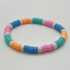 May include: A colourful beaded bracelet with alternating blue, white, orange and pink beads.