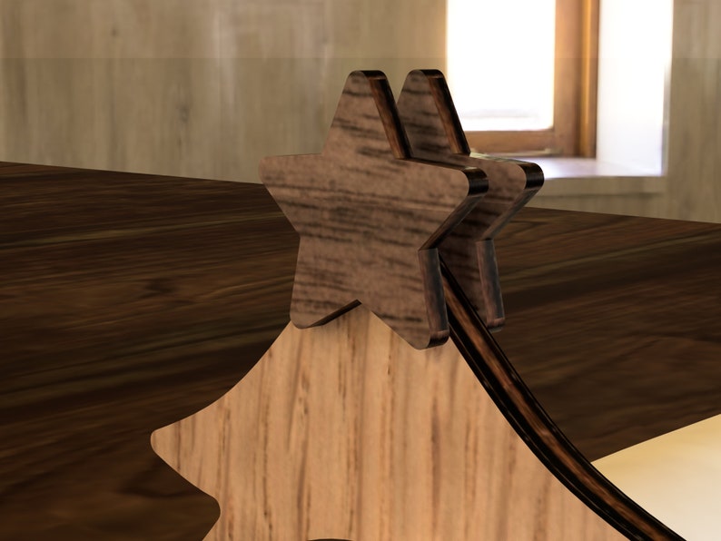 May include: Wooden Christmas tree ornament with two layered star shapes on top. The star shapes are made of dark wood and have a natural wood grain.