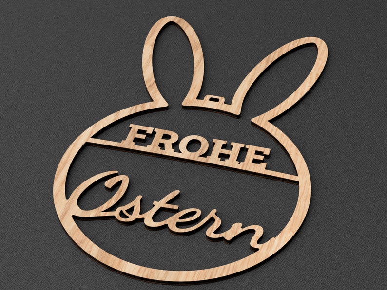 Może przedstawiać: Drewniana ozdoba wielkanocna w kształcie kr&oacute;lika z napisem "Frohe Ostern" w języku niemieckim.