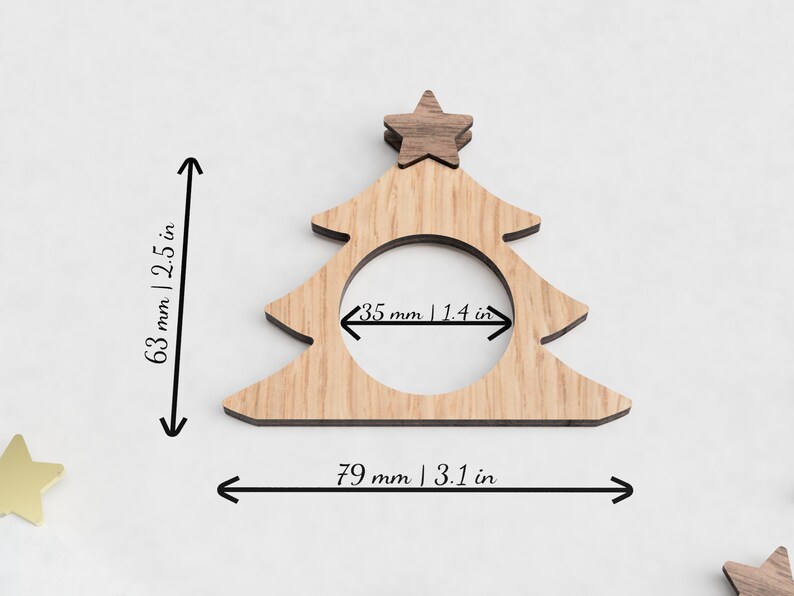 May include: Wooden Christmas tree napkin ring with a star on top. The ring measures 3.1 inches wide and 2.5 inches tall. The opening for the napkin is 1.4 inches wide.