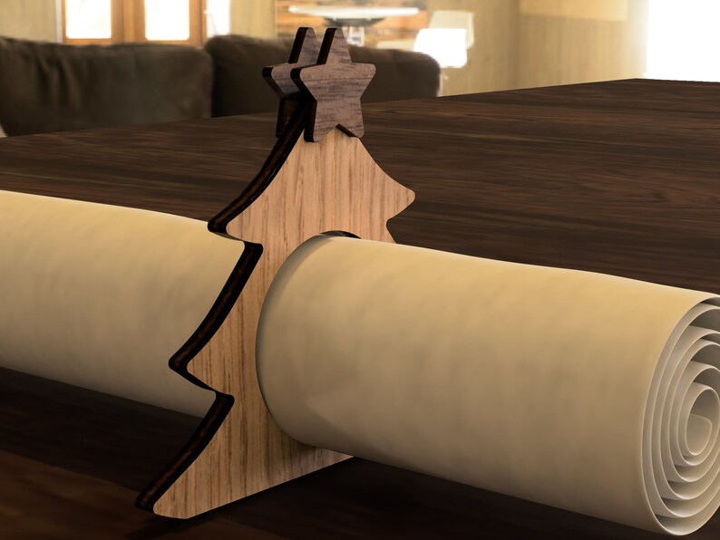 May include: Wooden Christmas tree napkin ring with two star accents. The ring is made of light brown wood and has a natural wood grain finish.