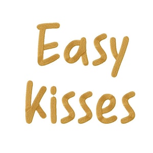 May include: Gold embroidered text that reads "Easy Kisses" on a white background.