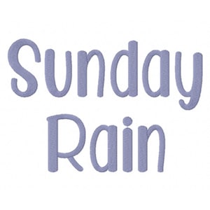 May include: The words "Sunday Rain" are embroidered in a light purple color on a white background. The letters are in a rounded, cursive style, with a textured appearance. The overall design is simple and clean.