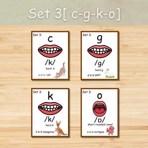 May include: Four flashcards with illustrations for phonics. Each card features a letter (c, g, k, o), a mouth graphic, and a corresponding image (cat, goat, kangaroo, octopus). The text "Set 3" is at the top of each card.