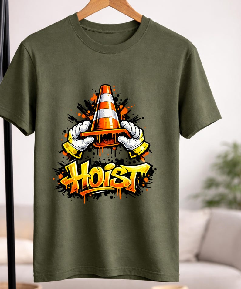 May include: Olive green t-shirt featuring a graphic of a traffic cone held by cartoon hands with yellow gloves. The word "Hoist" is written in orange graffiti-style lettering below the cone.