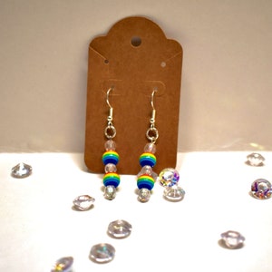 May include: Rainbow beaded dangle earrings with clear crystal beads and silver hooks.