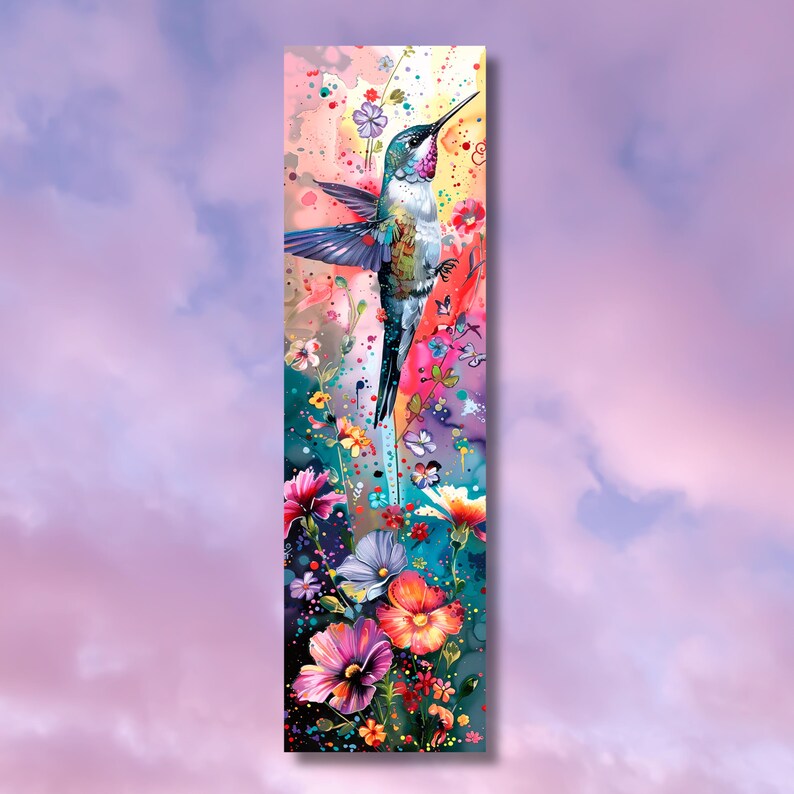 May include: A colorful hummingbird with blue, green, and white feathers is flying over a field of pink, purple, and yellow flowers. The background is a soft pink and purple watercolor wash.