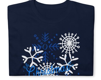 May include: A navy blue t-shirt with a white and blue snowflake design and the word "Christmas" in blue lettering.
