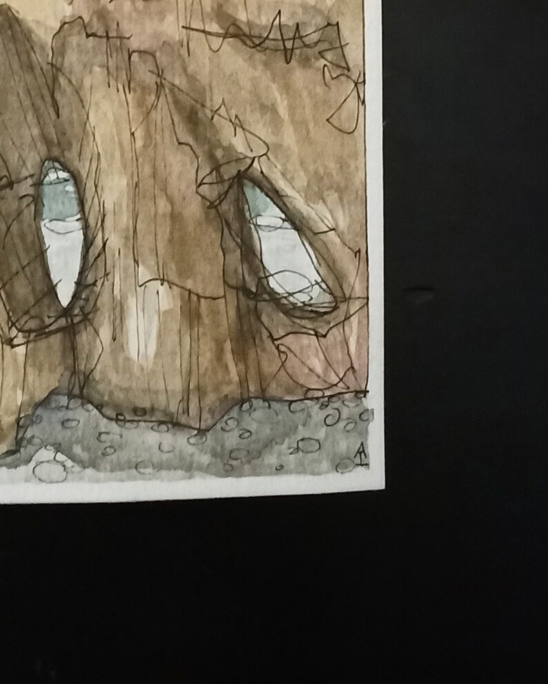 May include: A watercolour painting of a brown rock formation with two white eye-like shapes. The rock formation is painted in a textured style with brown and black lines. The background is a light brown colour.