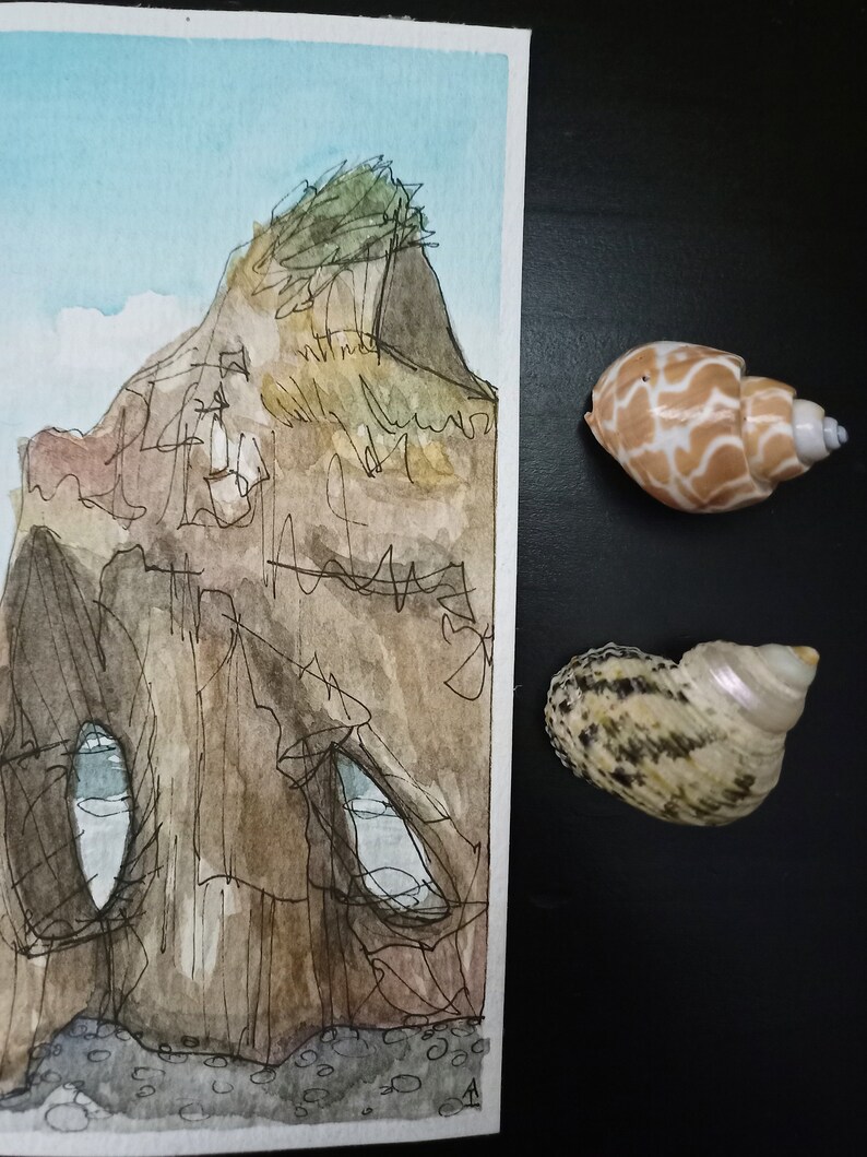 May include: A watercolour painting of a cliff with a small tree on top. The cliff has a cave-like opening with a blue sky visible inside. The painting is on a white background.