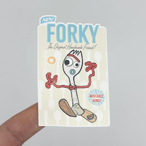 May include: A rectangular sticker featuring Forky, a character from Toy Story. Forky is a white fork with googly eyes, red pipe cleaner arms, and wooden feet. The sticker has the text "NEW! FORKY The Original Handmade Friend!" and "MOVEABLE ARMS!"