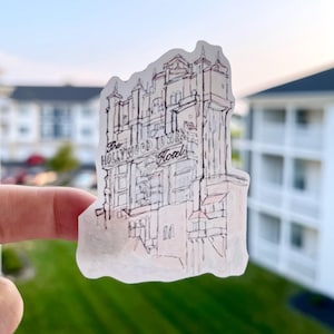 May include: A transparent sticker featuring a sketch of The Hollywood Tower Hotel. The artwork is in black and white with red accents, showcasing the building's architectural details. The text "The Hollywood Tower Hotel" is visible.
