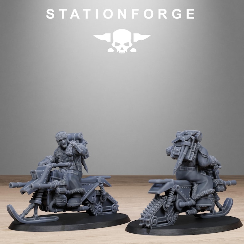 May include: Two gray miniature snowmobiles with figures, set on black bases. The snowmobiles have detailed tracks, skis, and what appear to be weapons. The figures are wearing winter gear. The word "STATIONFORGE" and a skull logo are at the top.