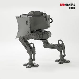 May include: A gray, mechanical walker model with a boxy body, articulated legs, and a detailed head. The model has rivets and other mechanical details. The Redmakers logo is in the top right corner.