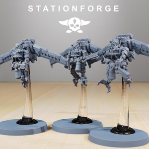 May include: Three gray plastic miniature figures of flying robots with guns, on clear plastic stands. The robots have a steampunk aesthetic and are posed in mid-flight. The stands are on a gray surface. The image includes the text "STATIONFORGE".