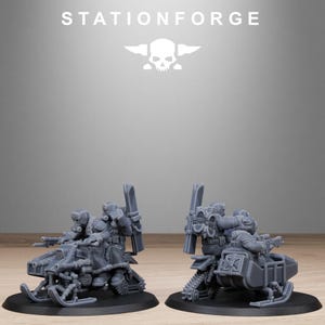 May include: Two gray miniature models of snowmobiles with detailed weaponry and figures. The models are on black bases, with the text "STATIONFORGE" and a skull logo above them. The snowmobiles have skis and tracks.