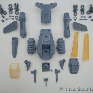 May include: A set of unassembled gray plastic model pieces for a spaceship. The pieces include the main body, wings, engines, and other details. The model is designed to be assembled and painted.