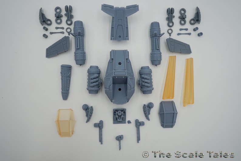May include: A set of unassembled gray plastic model pieces for a spaceship. The pieces include the main body, wings, engines, and other details. The model is designed to be assembled and painted.