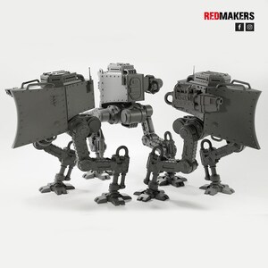 May include: Three gray, mechanical walker models with detailed armor plating and articulated legs. Each model features a central body, a shield, and weapon attachments. The Redmakers logo is visible in the top right corner.
